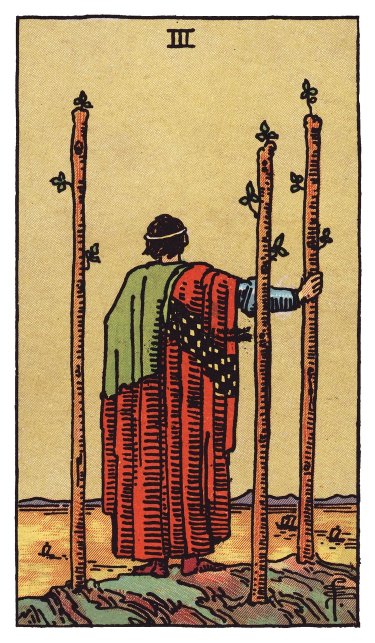 A cloaked figure watches ships sail out from a high vantage, three wands planted firmly around him.